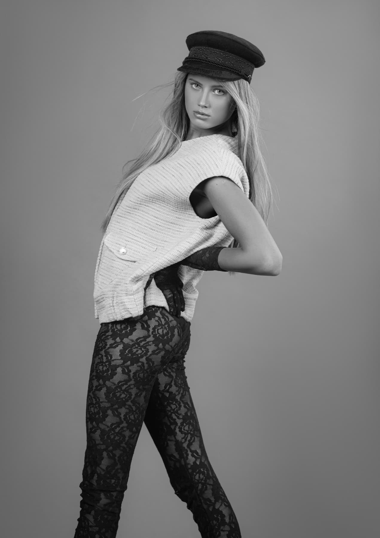 Black and white studio portrait with cap
